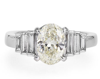 Warm Toned 1.50 carat Oval Cut Diamond in Platinum Engagement Ring with Graduated Baguettes