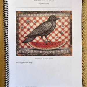 May include: A cross stitch chart titled "CROW on WATERMELON." The design features a detailed black crow perched on a watermelon slice, set against a red and white checkered background with stars. The chart's design size is 225 x 180 stitches.