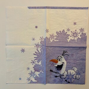 May include: A square paper napkin featuring a light purple and white color scheme with a pattern of various snowflakes. The character Olaf is printed in the bottom right corner, depicted with a carrot nose, wide smile, and stick-like arms.