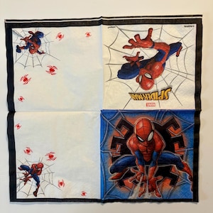 May include: A square paper napkin featuring Spider-Man graphics. The design includes red and blue Spider-Man figures, white spider webs, and small red spider icons. The text Spider-Man and Marvel are printed on the napkin with a black border.