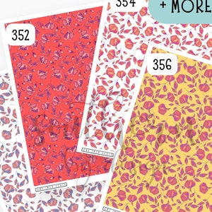 May include: Three sheets of patterned paper with floral designs. The paper is white with red, yellow, and pink flowers. The numbers 350, 352, and 356 are printed on the sheets. The text "More Sizes" is printed on the top sheet.