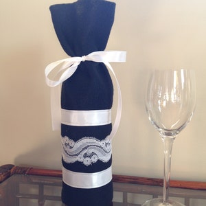 Felt Wine Bottle Gift Bag in Black Decorated with White Lace and Ribbon.