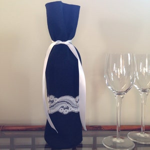 Felt Wine Bottle Gift Bag in Black Felt Decorated with White Lace and Ribbon.