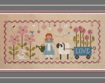 Lili in the Garden, counted cross stitch chart.  Flowers, sheep, rabbit and Lili watering plants.