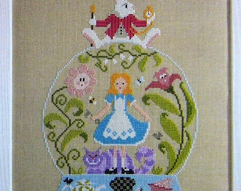 Alice in Wonderland Snow Globe design counted cross stitch chart.