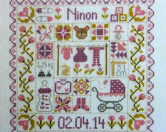 Patchwork Baby – counted cross stitch chart to work in 8 colours of DMC thread. Pink and Blue Traditional style patchwork houses and motifs.