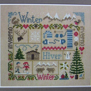 Winter Sampler – counted cross stitch chart. Winter motifs and European words. Winter design