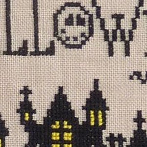 May include: Cross-stitch pattern featuring a black silhouette of a spooky Halloween town with a yellow moon and the word "HALLOWEEN" in black.
