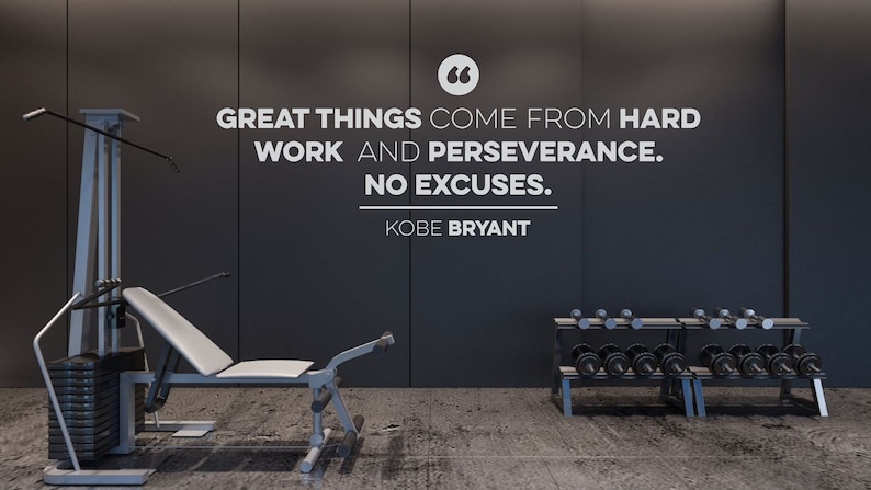 May include: A home gym with a weight machine, dumbbells, and a motivational quote on the wall that reads "GREAT THINGS COME FROM HARD WORK AND PERSEVERANCE. NO EXCUSES. KOBE BRYANT"