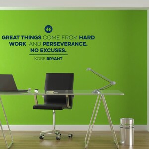 May include: A motivational quote by Kobe Bryant on a green wall in an office setting. The quote reads: "Great things come from hard work and perseverance. No excuses."