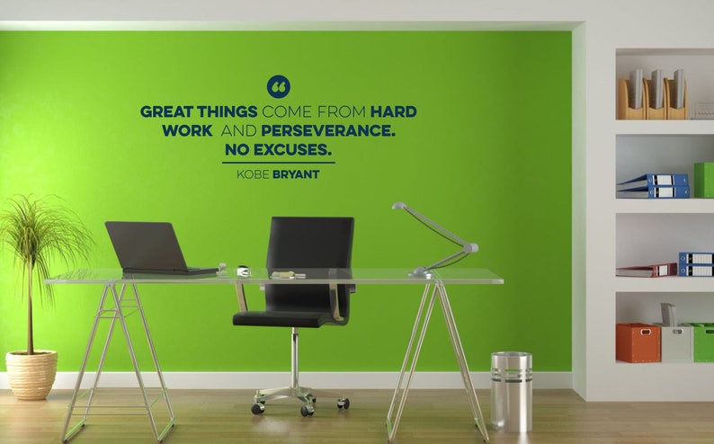 May include: A motivational quote by Kobe Bryant on a green wall in an office setting. The quote reads: "Great things come from hard work and perseverance. No excuses."
