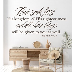 May include: A brown wooden wall with a white background featuring a bible verse quote: "But seek first His kingdom & His righteousness and all those things will be given to you as well. Matthew 6:33"