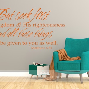 May include: A teal armchair with a brown throw blanket sits in a room with a gray wall. The wall has a vinyl decal with the text "But seek first His kingdom & His righteousness and all these things will be given to you as well. Matthew 6:33".