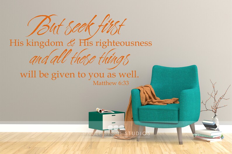 May include: A teal armchair with a brown throw blanket sits in a room with a gray wall. The wall has a vinyl decal with the text "But seek first His kingdom & His righteousness and all these things will be given to you as well. Matthew 6:33".