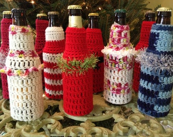 May include: Seven crocheted bottle covers in various colors and patterns, including red and white stripes, blue and white stripes, and a white cover with pink and yellow accents. The covers are made with a textured stitch and are perfect for adding a festive touch to any beverage.