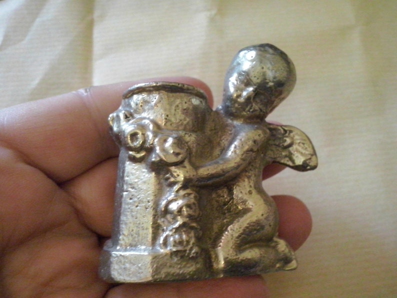 solid iron statue, candle holder, miniature cupid, small angel embracing a well, small angel statue, nude angel syr2 image 1