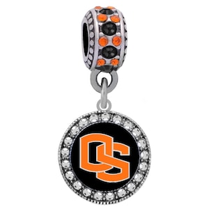 May include: Silver charm with a black and orange Oklahoma State University logo on a round charm with clear crystals around the edge. The charm is attached to a silver bead with orange and black crystals.