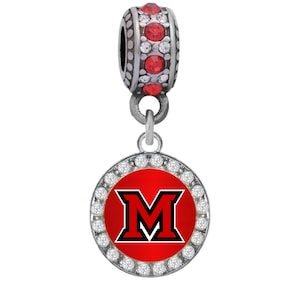May include: Silver charm with a red and black University of Miami 'M' logo surrounded by clear crystals. The charm is attached to a silver bead with red crystals.