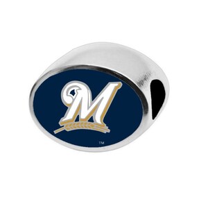 May include: Silver charm with a blue and gold Milwaukee Brewers logo. The logo features a white "M" with a wheat stalk underneath. The charm has a hole for attaching to a bracelet.