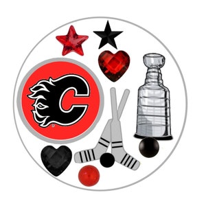 May include: A circular design featuring hockey-themed elements. Includes a red and black star, a red heart, a black heart, a hockey puck, hockey sticks, a Stanley Cup, and a red and black logo with the letter "C".