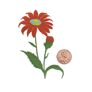 May include: Embroidered red daisy with a blue and yellow center, green stem, and leaves. A red flower bud is also present. A penny is next to the flower for size comparison. The flower is on a white background.