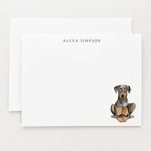 May include: White stationery with the name "ALEXA SIMPSON" printed at the top. A watercolor illustration of a black and tan dog sitting on the bottom right corner of the card.
