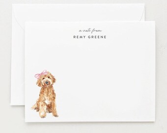 May include: A white card with a watercolor illustration of a brown dog wearing a pink bow. The text "a note from REMY GREENE" is printed in gray at the top of the card.