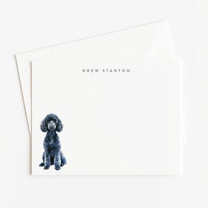 May include: White stationery set featuring a watercolor illustration of a black poodle. The stationery includes a folded card and an envelope. The name "DREW STANTON" is printed at the top of the card.
