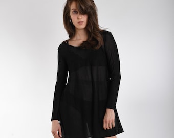 May include: A long-sleeved black tunic dress featuring a sheer, lightweight knit fabric with a subtle texture. The garment has a rounded neckline and a relaxed, straight-cut silhouette that falls above the knee, showcasing a semi-transparent finish.