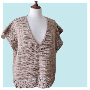 May include: A brown crocheted top with a deep V-neck and short sleeves. The top has a crocheted lace trim at the bottom.