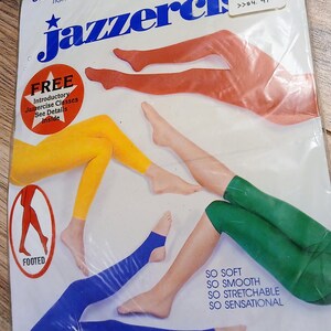 May include: Package of Ultra Soft Jazzerci tights in black. The packaging shows illustrations of legs wearing tights in red, yellow, green, and blue. The package also includes text that says "So Soft, So Smooth, So Stretchable, So Sensational."
