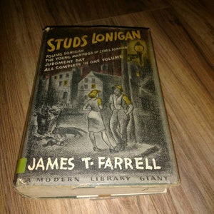 May include: A vintage book cover with a black and white illustration of a city street at night. The title is "Studs Lonigan" by James T. Farrell. The book is a Modern Library Giant.