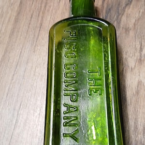 Antique The Pisos Company Hazeltine green glass bottle