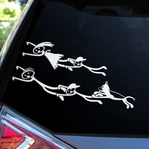 May include: A white car with a black rear window. The window has a white sticker of a family of stick figures with a dog running behind them.