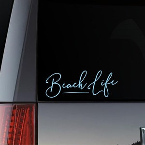 May include: A blue and white car decal with the text "Beach Life" in a cursive font.