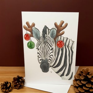 Zebra met kerstballen Kerstkaart hypermobiliteit EDS ehlers danlos syndroom