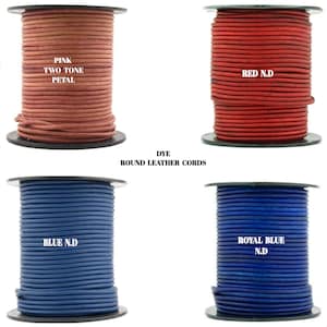 May include: Four spools of round leather cord in different colors: pink, red, blue, and royal blue. The spools are labeled with the color and "N.D." for "Not Dyed". The text "DYE ROUND LEATHER CORDS" is printed below the spools.