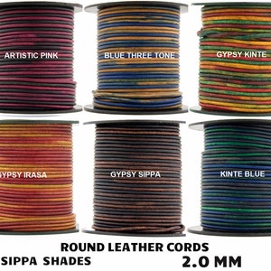 May include: Six spools of 2.0 mm round leather cord in various colors and patterns, including Artistic Pink, Blue Three Tone, Gypsy Kinte, Gypsy Irasa, Gypsy Sippa, and Kinte Blue.  The spools are labeled with the color names.  The text "ROUND LEATHER CORDS" and "SIPPA SHADES" are printed below the spools.  The text "2.0 MM" is printed below the text "SIPPA SHADES".