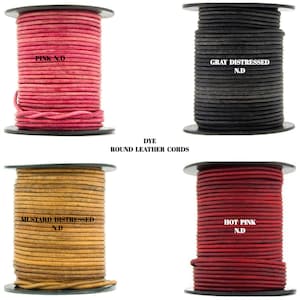 May include: Four spools of round leather cord in different colors: pink, gray, mustard, and red. The spools are labeled with the color and "N.D." The text "DYE ROUND LEATHER CORDS" is printed below the spools.