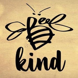 May include: A black graphic of a bee with the word "bee" incorporated into the design, and the word "kind" below it. The design is on a light brown, wood-grain background.