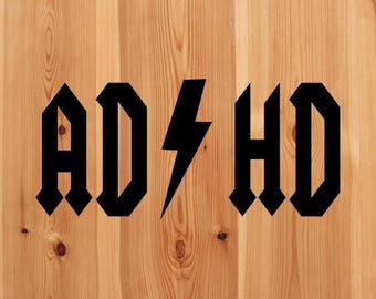 May include: Black and white graphic design with the text "AD/HD" in a bold, gothic font style. The letters are stylized with pointed edges and the lightning bolt symbol is between the "D" and "H".