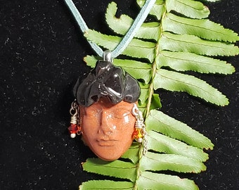 Clay Face Bead with Red Spirals