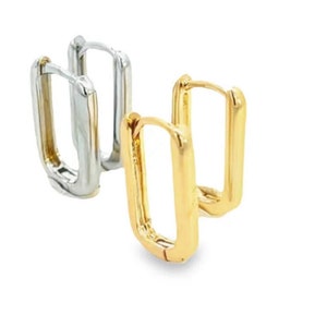 May include: A pair of hoop earrings, one gold and one silver, with a rectangular shape.