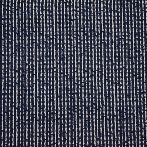 May include: A close-up of a navy blue fabric featuring a pattern of vertical white lines. The lines are irregular, creating a textured effect, similar to a woven or printed design. The overall impression is of a contemporary, abstract pattern.