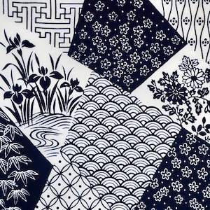 May include: A white fabric with a patchwork design featuring various Japanese patterns in black and white. The patterns include waves, flowers, and geometric shapes.