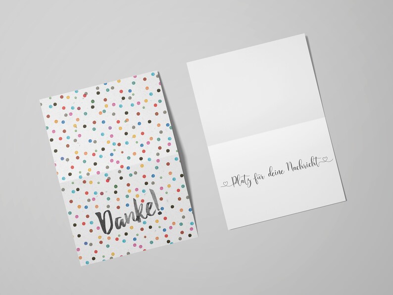 May include: A white card with a colorful confetti pattern and the word "Danke!" printed in black. The inside of the card is blank with the text "Platz f&uuml;r deine Nachricht" printed in black.