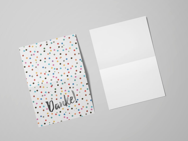 May include: A folded card with a white background and a colorful polka dot pattern. The card says "Danke!" in black script.