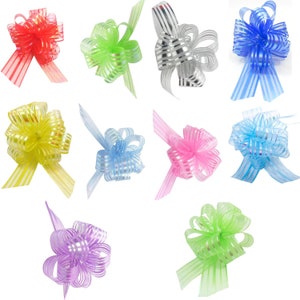 May include: Assortment of ten colourful, striped, sheer ribbon bows. The bows are made of a thin, translucent material with a shimmery finish. The bows are tied in a simple knot and have long tails.