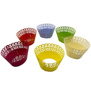 May include: Six cupcake cases in a variety of colours, including red, purple, green, yellow, cream, and pink. The cases have a lacy design and are made of paper.