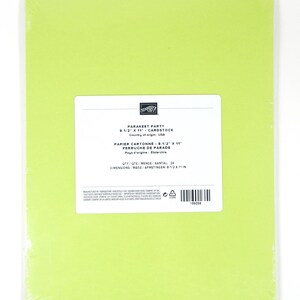 May include: A pack of bright green cardstock paper, measuring 21.6 x 27.9 cm, wrapped in clear plastic. The label reads "PARAKEET PARTY" and "CARDSTOCK". The quantity is 24 sheets. Made in the USA.